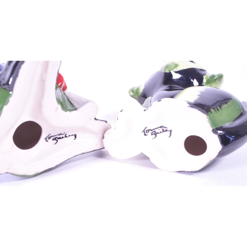 396 - Lorna Bailey (B. 1978) - Two contemporary art deco style ceramic cat figures. Comprised of a fisherm... 