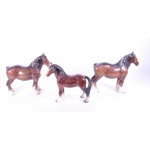411 - John Beswick - A collection of three china porcelain Shire horse figurine / statues. Two with braids... 