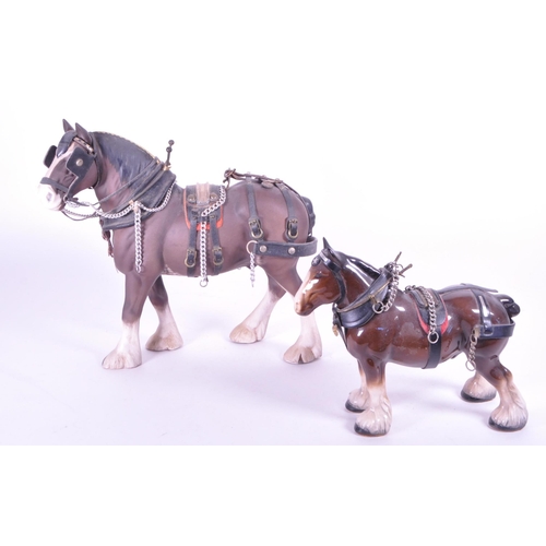 413 - Beswick - Two china porcelain horse figurines. Including Clydesdale Shire horse 2465 in working harn... 