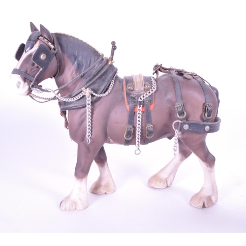 413 - Beswick - Two china porcelain horse figurines. Including Clydesdale Shire horse 2465 in working harn... 