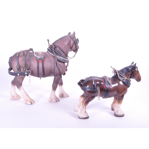 413 - Beswick - Two china porcelain horse figurines. Including Clydesdale Shire horse 2465 in working harn... 