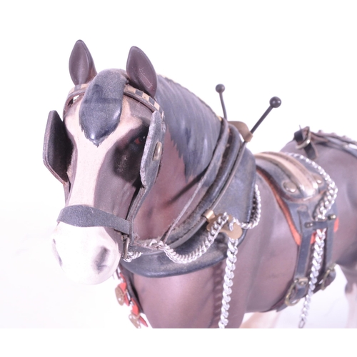 413 - Beswick - Two china porcelain horse figurines. Including Clydesdale Shire horse 2465 in working harn... 