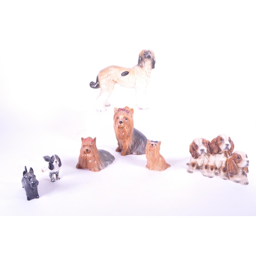 414 - Beswick - A collection of mid century & later porcelain china dog figurines. To include three va... 