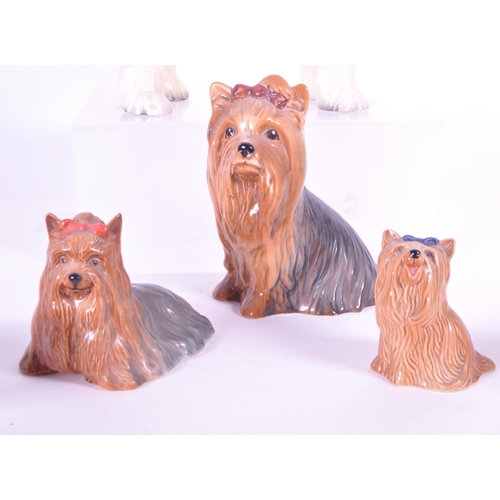 414 - Beswick - A collection of mid century & later porcelain china dog figurines. To include three va... 