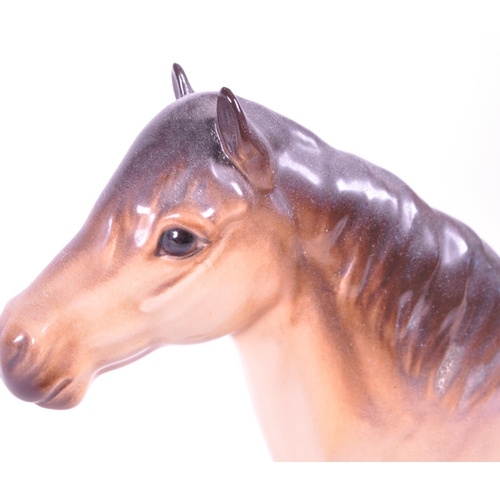 415 - Beswick - A porcelain china Highland Mackionneach Dun pony horse. Standing postion, line to back and... 