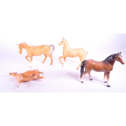 417 - Beswick - A collection of four porcelain china horse figurine / statues. To include a palomino, pran... 