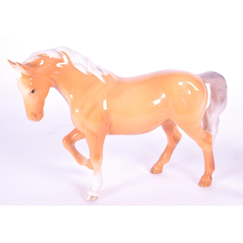417 - Beswick - A collection of four porcelain china horse figurine / statues. To include a palomino, pran... 