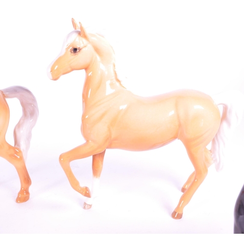 417 - Beswick - A collection of four porcelain china horse figurine / statues. To include a palomino, pran... 