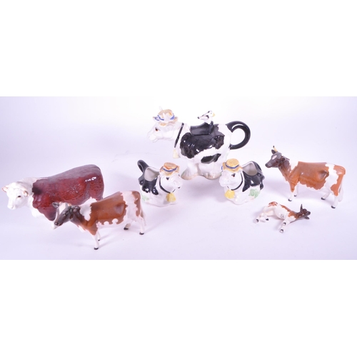 418 - Beswick - A collection of porcelain cow figurines / statues. Three Beswick examples with makers mark... 
