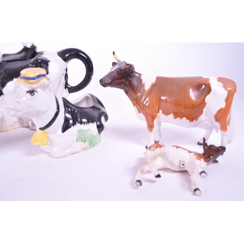 418 - Beswick - A collection of porcelain cow figurines / statues. Three Beswick examples with makers mark... 