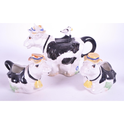 418 - Beswick - A collection of porcelain cow figurines / statues. Three Beswick examples with makers mark... 