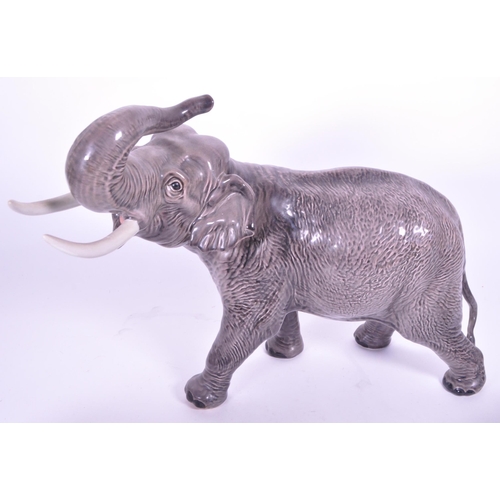 419 - Large Beswick elephant with trunk curled upwards, stamp to base of one  foot, along with a similar s... 