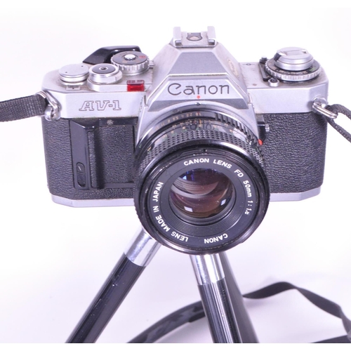 214 - A collection of vintage 20th century cameras and lenses. To include, Canon AV-1, Agfa Isolette, made... 