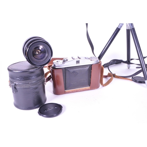 214 - A collection of vintage 20th century cameras and lenses. To include, Canon AV-1, Agfa Isolette, made... 