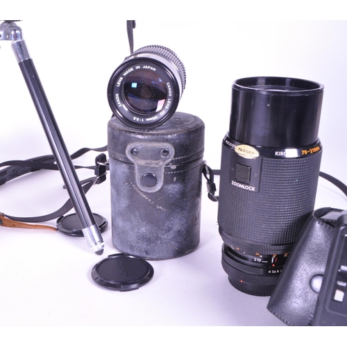 214 - A collection of vintage 20th century cameras and lenses. To include, Canon AV-1, Agfa Isolette, made... 