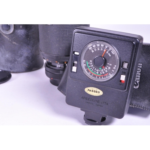 214 - A collection of vintage 20th century cameras and lenses. To include, Canon AV-1, Agfa Isolette, made... 