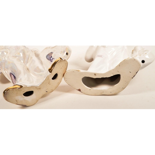 171 - Two large late 20th century ceramic white and gilt clown figures. Both depicted holding a cello, one... 