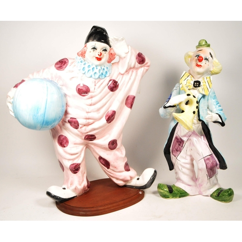 172 - Two large late 20th century vintage ceramic clown figures. Comprised of one positioned holding a bal... 