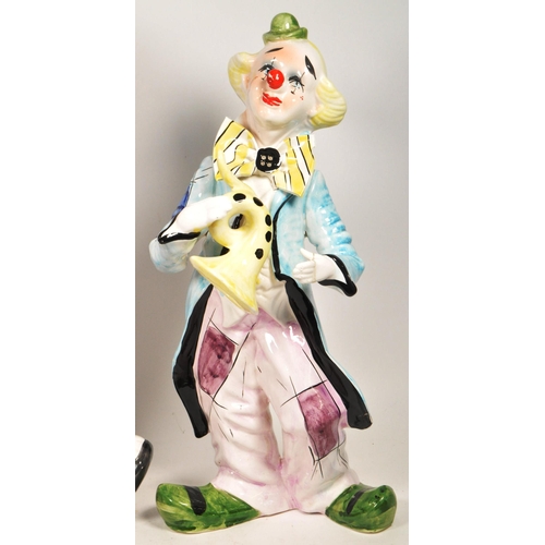 172 - Two large late 20th century vintage ceramic clown figures. Comprised of one positioned holding a bal... 