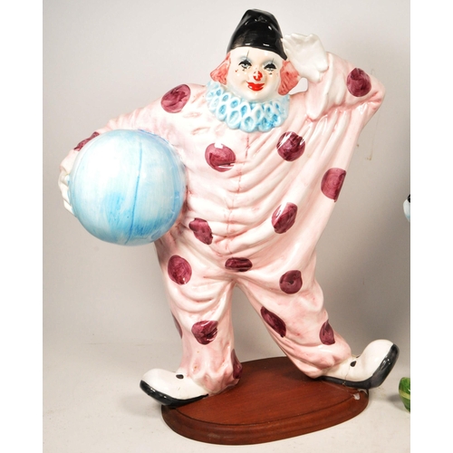 172 - Two large late 20th century vintage ceramic clown figures. Comprised of one positioned holding a bal... 