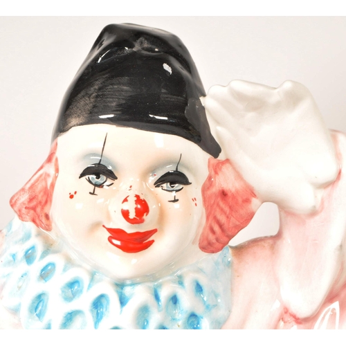172 - Two large late 20th century vintage ceramic clown figures. Comprised of one positioned holding a bal... 