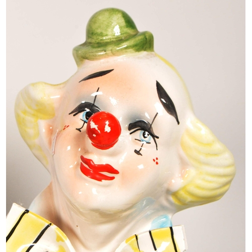 172 - Two large late 20th century vintage ceramic clown figures. Comprised of one positioned holding a bal... 