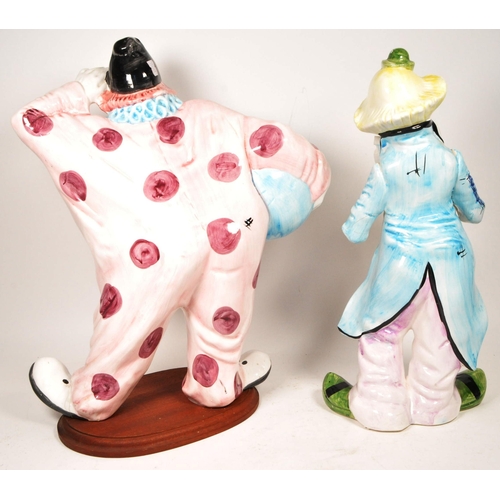 172 - Two large late 20th century vintage ceramic clown figures. Comprised of one positioned holding a bal... 