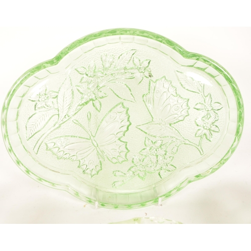 126 - A collection of mid 20th century vaseline glass decorative items. The collection to include candlest... 