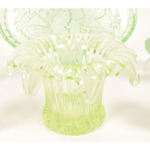 126 - A collection of mid 20th century vaseline glass decorative items. The collection to include candlest... 