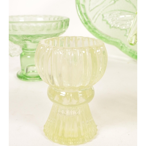 126 - A collection of mid 20th century vaseline glass decorative items. The collection to include candlest... 