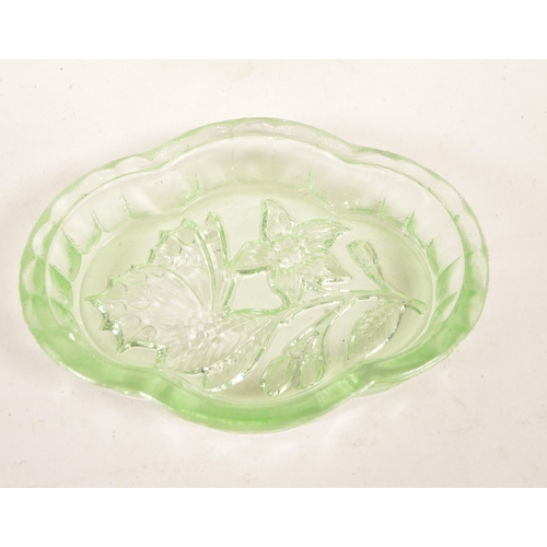 126 - A collection of mid 20th century vaseline glass decorative items. The collection to include candlest... 