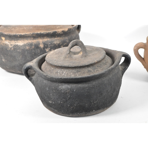 23 - Four Roman style earthenware clay pottery twin handled pots. Two of the pots with fitted lids, anoth... 
