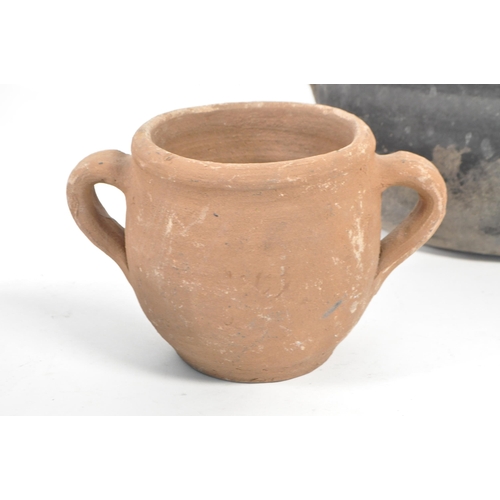 23 - Four Roman style earthenware clay pottery twin handled pots. Two of the pots with fitted lids, anoth... 