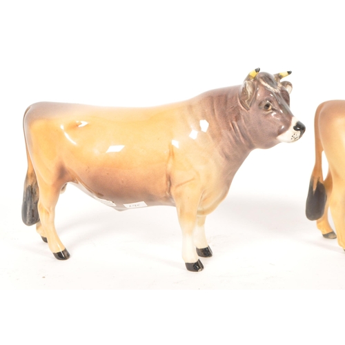 33 - Beswick - Two vintage 20th century Beswick china cow figures. The collection to include two No. 1422... 