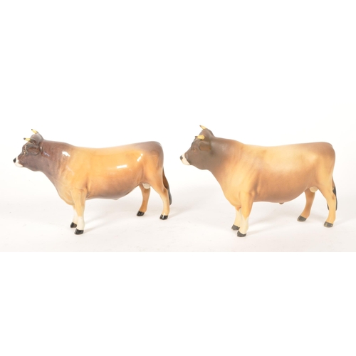 33 - Beswick - Two vintage 20th century Beswick china cow figures. The collection to include two No. 1422... 