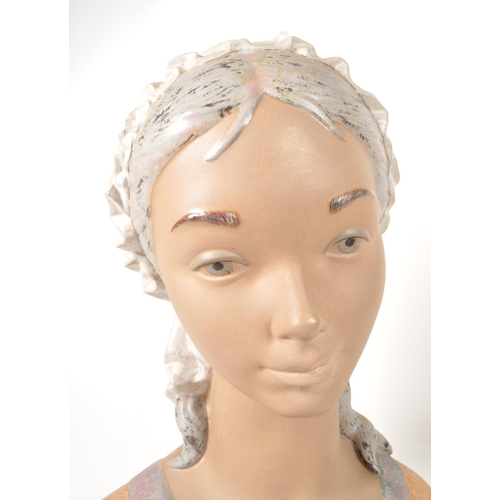 45 - Late 20th century Lladro porcelain 'Little Girl' bust numbered 1202 with a Nao porcelain 'Girl at We... 