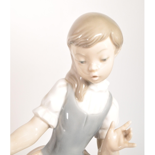 45 - Late 20th century Lladro porcelain 'Little Girl' bust numbered 1202 with a Nao porcelain 'Girl at We... 