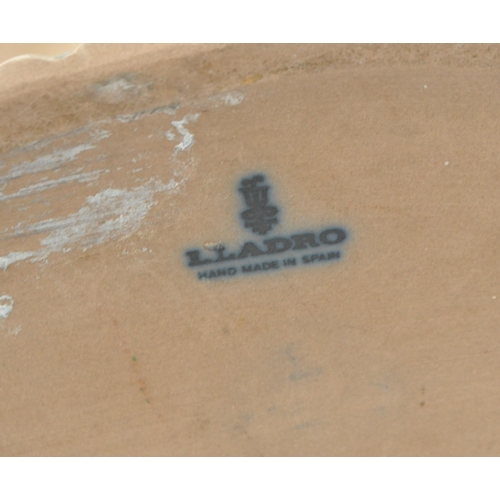 45 - Late 20th century Lladro porcelain 'Little Girl' bust numbered 1202 with a Nao porcelain 'Girl at We... 