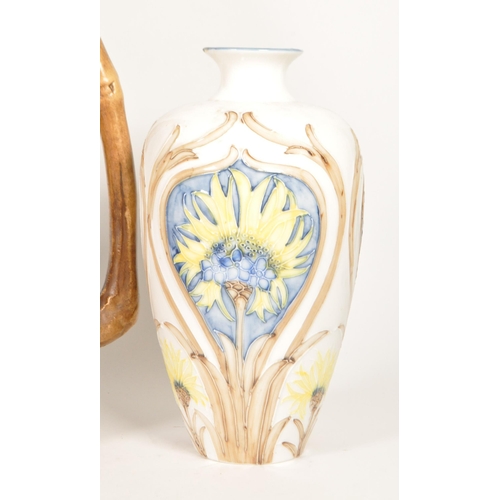 47 - Four 20th century pottery vases. Comprised of an early 20th century Bretby twin handled vase, model ... 