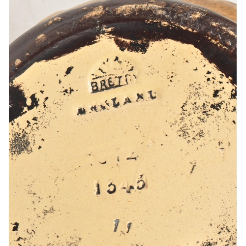 47 - Four 20th century pottery vases. Comprised of an early 20th century Bretby twin handled vase, model ... 