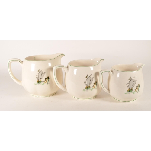 49 - New Hall Pottery - Three graduating mid century 1950s earthenware Staffordshire jugs. Each decorated... 