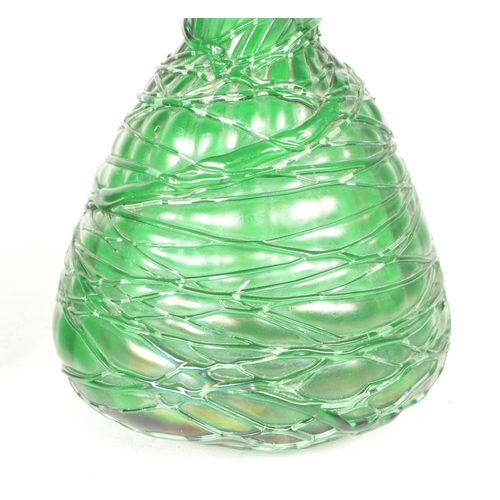 56 - Manner of Loetz - Two 20th century art nouveau style green glass vases / bottles. Featuring a strapp... 