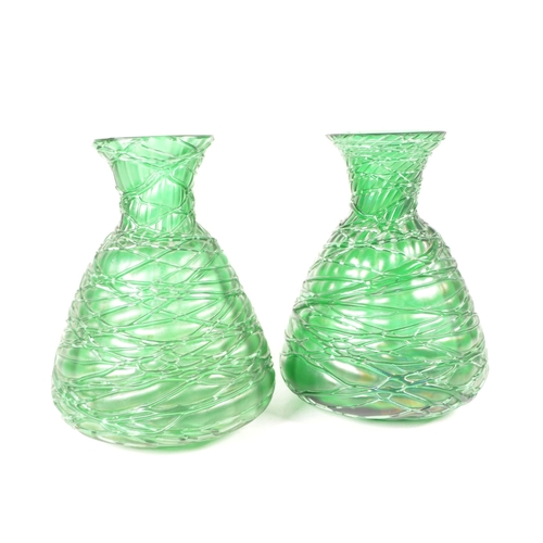 56 - Manner of Loetz - Two 20th century art nouveau style green glass vases / bottles. Featuring a strapp... 