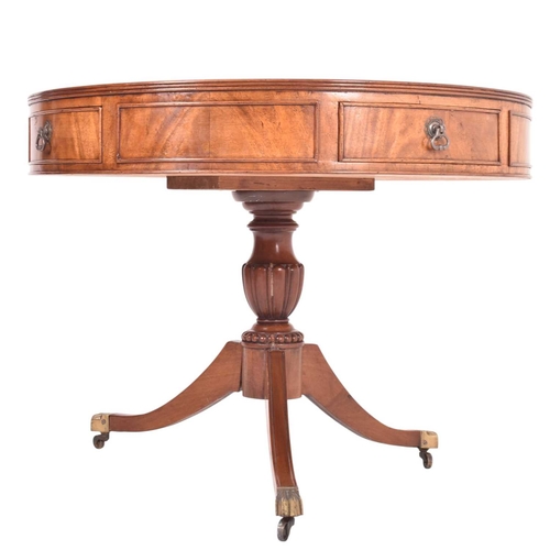 A late Victorian 19th century flame mahogany drum rent table. The table ...