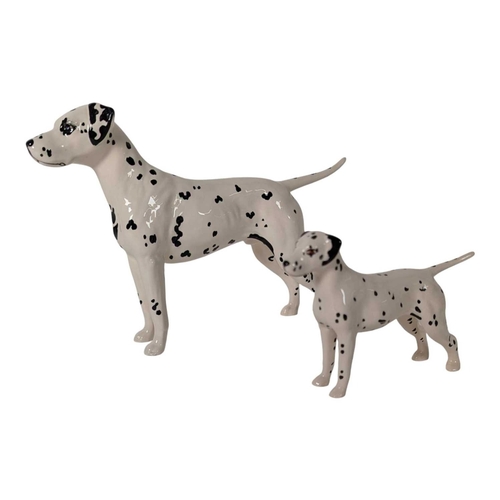 115 - Beswick - A collection of vintage 20th century Dalmatian dog porcelain figures. Including mum, dad a... 
