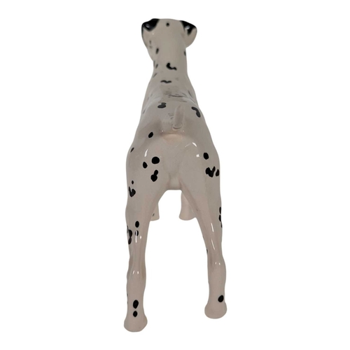 115 - Beswick - A collection of vintage 20th century Dalmatian dog porcelain figures. Including mum, dad a... 