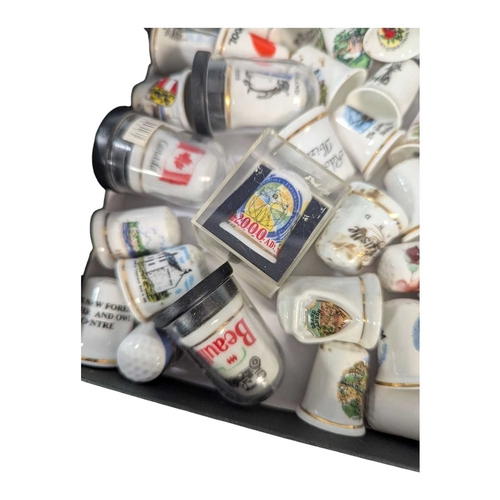 136 - A collection of 20th century commemorative souvenir bone china thimbles. The collection including ex... 