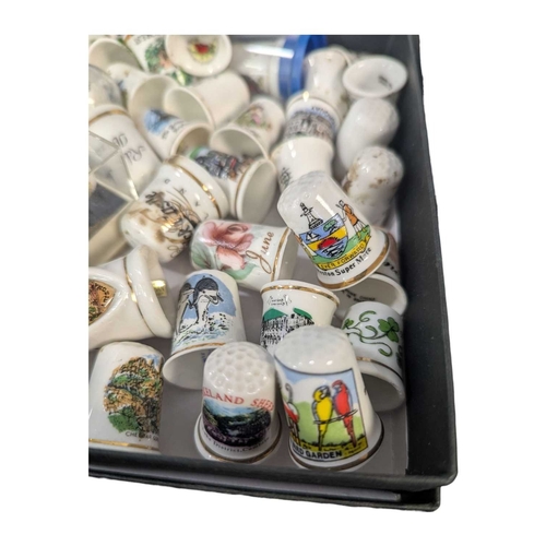 136 - A collection of 20th century commemorative souvenir bone china thimbles. The collection including ex... 
