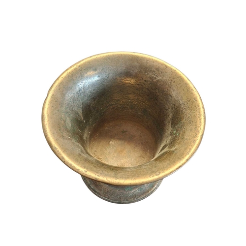 167 - An 18th century brass pestle and mortar. Having flared rim to top with rounded stepped base. Featuri... 