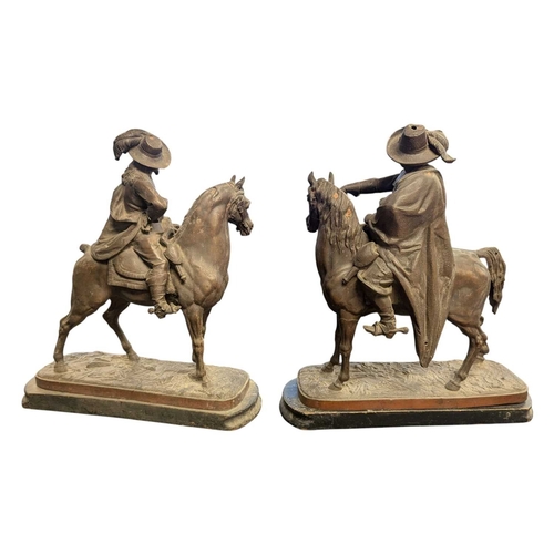173 - Two early 20th century bronzed spelter sculptures of cavalier figures on horseback. Both raised on w... 